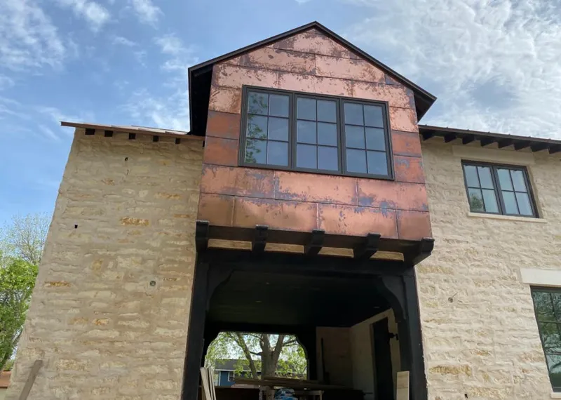 Copper metal panel facade on a stone building for Skylight Installation in Robeson