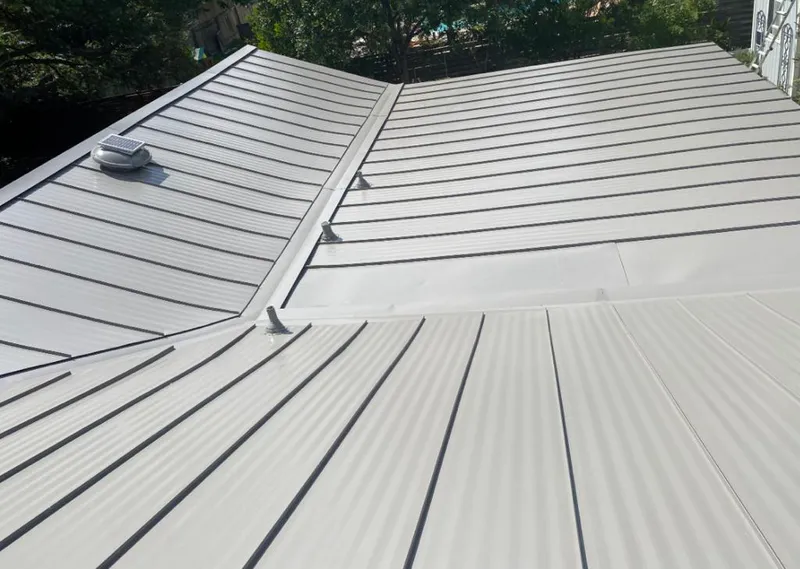 Solar attic fan installed on a metal roof for Roof Ventilation in Robeson